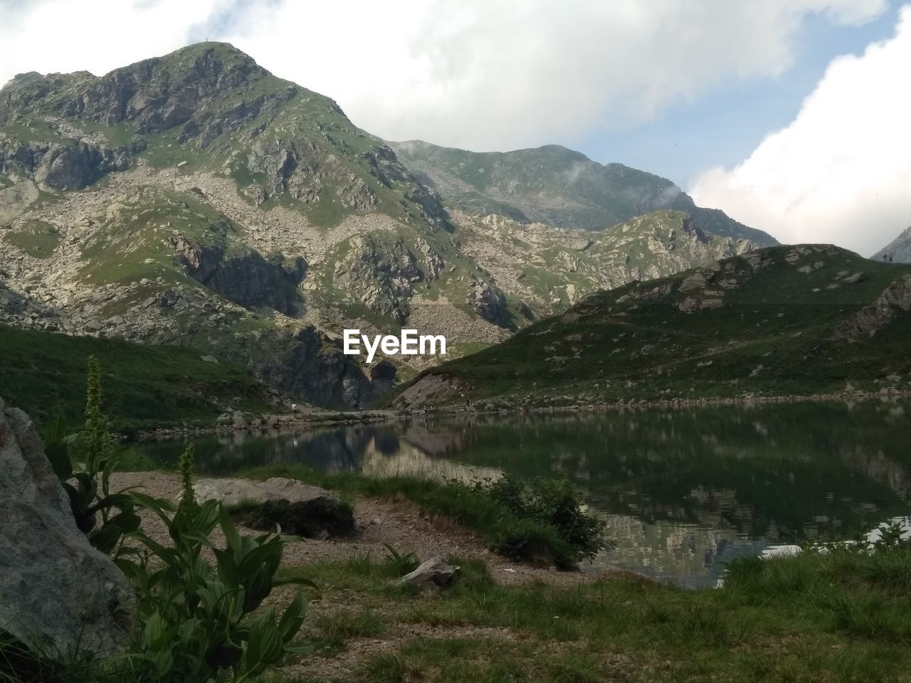 Scenic view of lake and mountains against sky