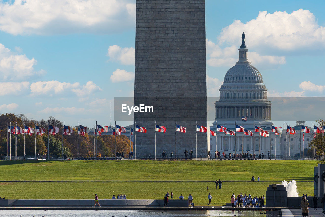 landmark, architecture, built structure, building exterior, travel destinations, government, sky, travel, cloud, city, tower, nature, tourism, politics, memorial, crowd, group of people, large group of people, dome, politics and government, outdoors, skyline, day, flag, history, the past