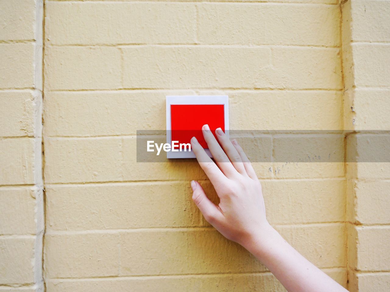 Close-up of hand pressing door bell