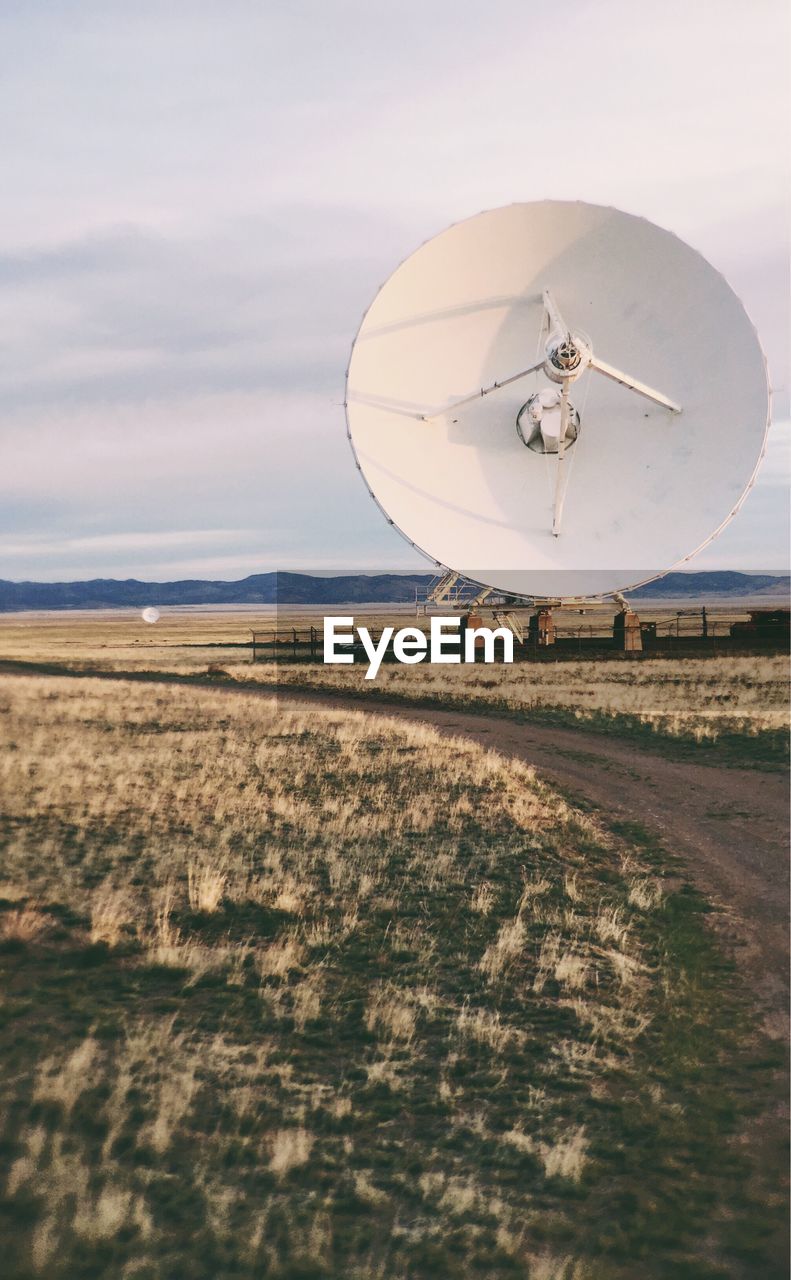 View of dish antenna on countryside landscape