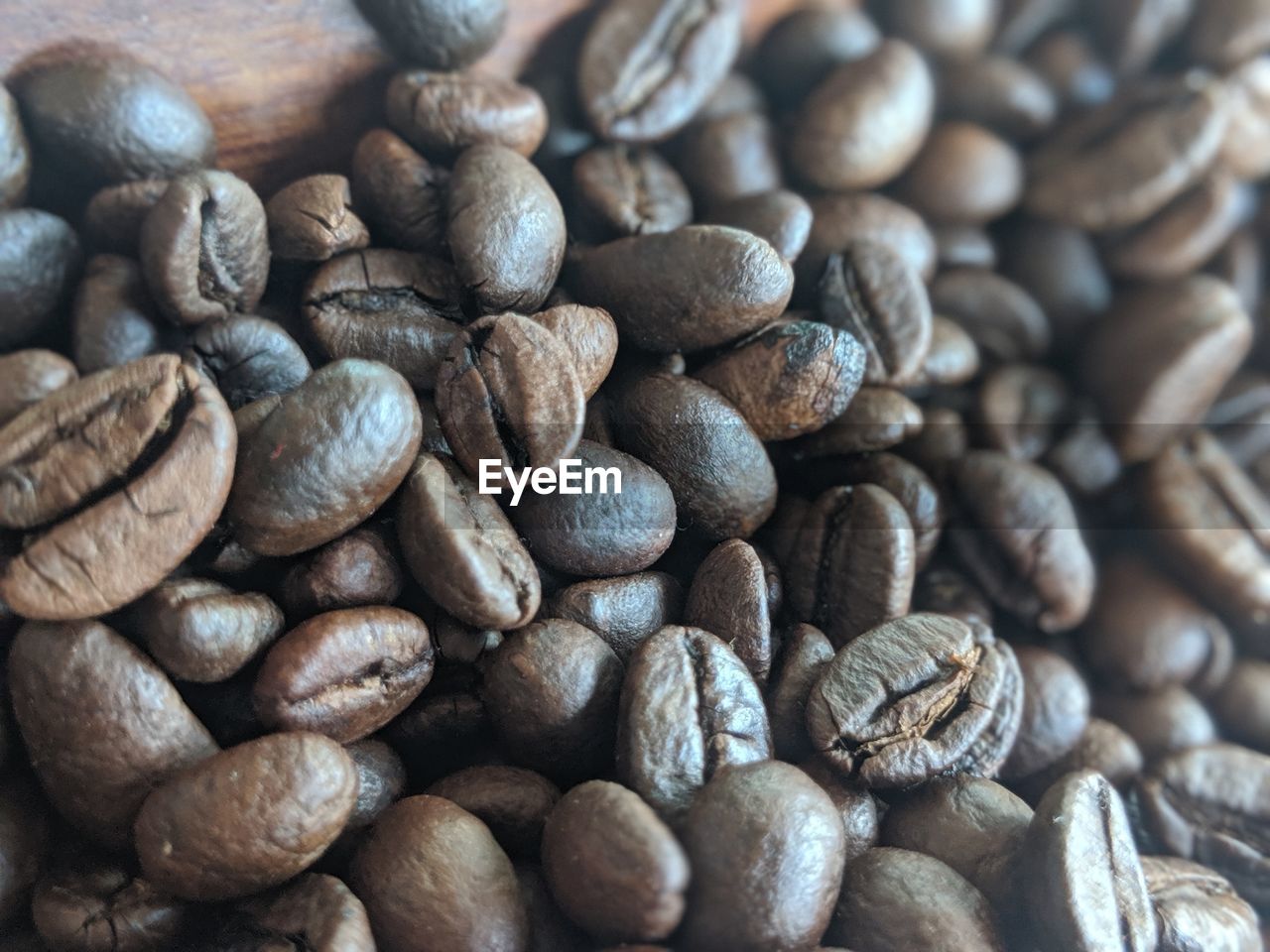 FULL FRAME SHOT OF COFFEE BEANS IN BACKGROUND