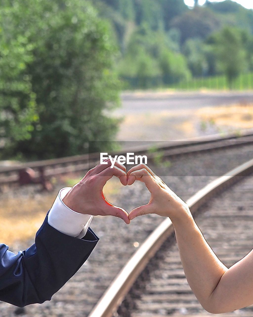 CLOSE-UP OF HAND HOLDING HEART SHAPE