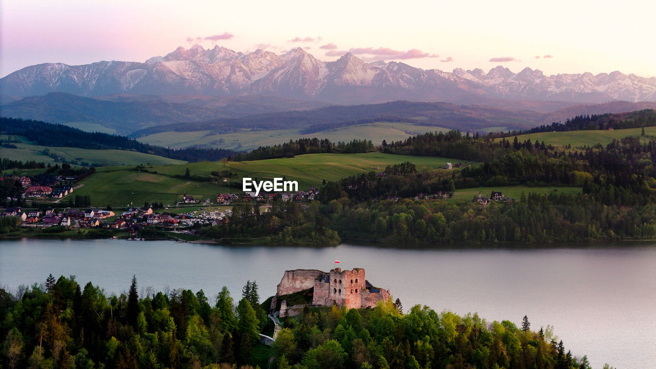 scenic view of lake and mountains against sky during sunset