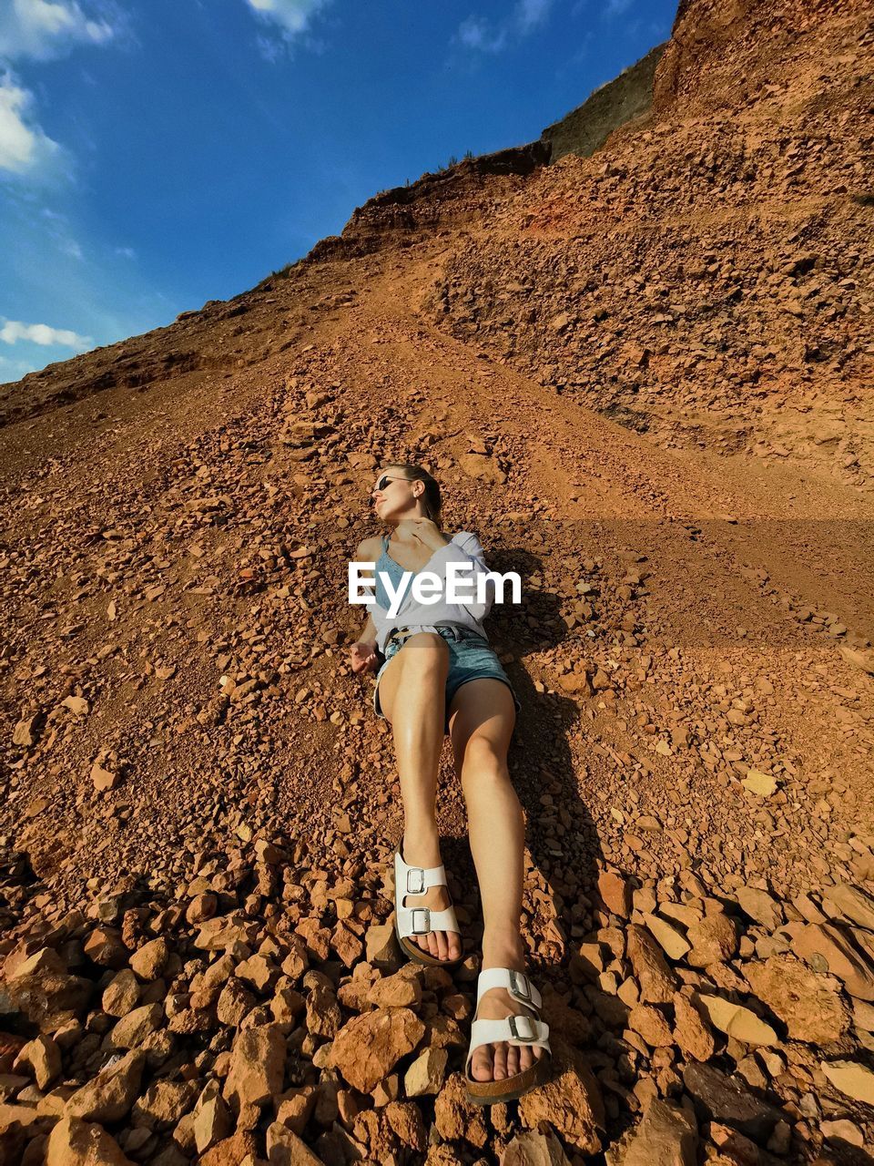 WOMAN STANDING ON ROCK