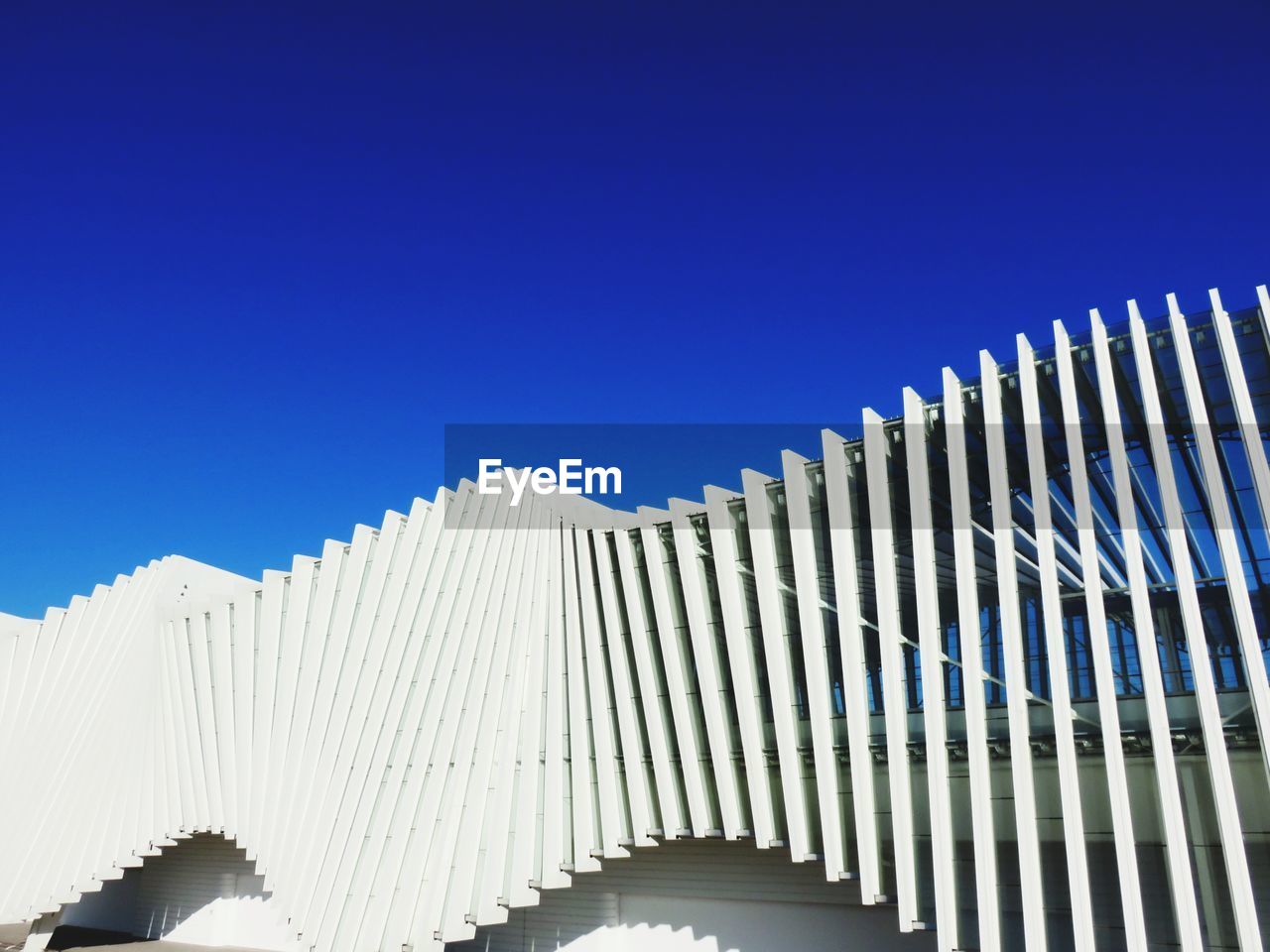 LOW ANGLE VIEW OF BUILT STRUCTURES AGAINST CLEAR BLUE SKY