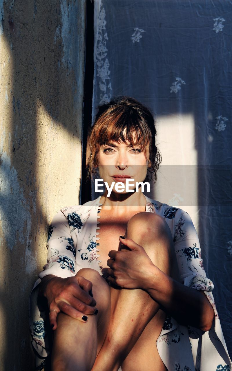 High angle view of woman standing against wall