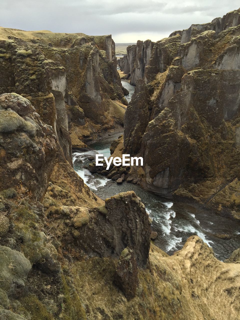 Rock formations by sea against sky