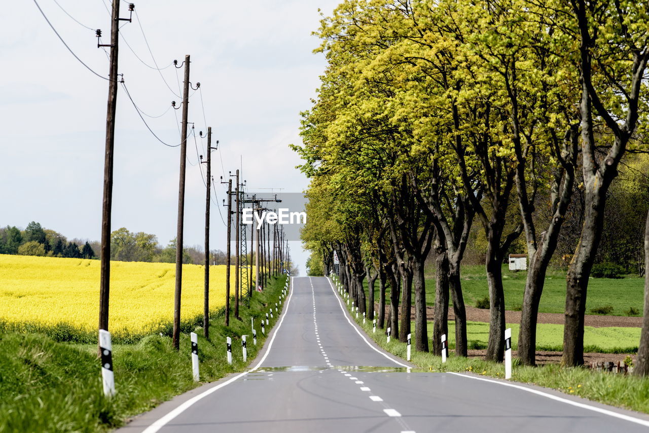 Empty road along countryside landscape