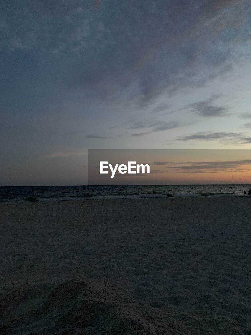 SCENIC VIEW OF BEACH AGAINST SKY DURING SUNSET