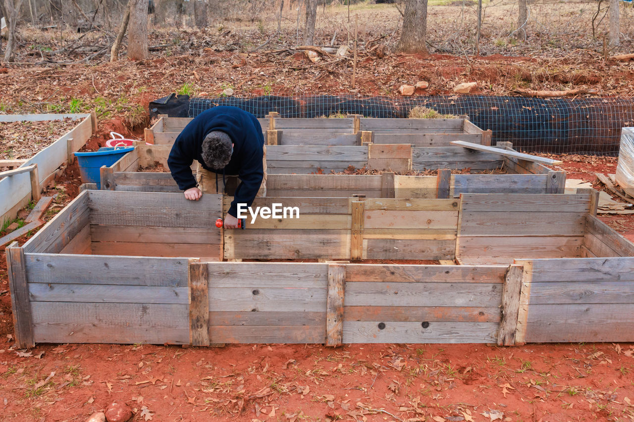 wood, men, one person, day, wall, working, nature, occupation, adult, full length, soil, person, outdoors, lifestyles, land, backyard