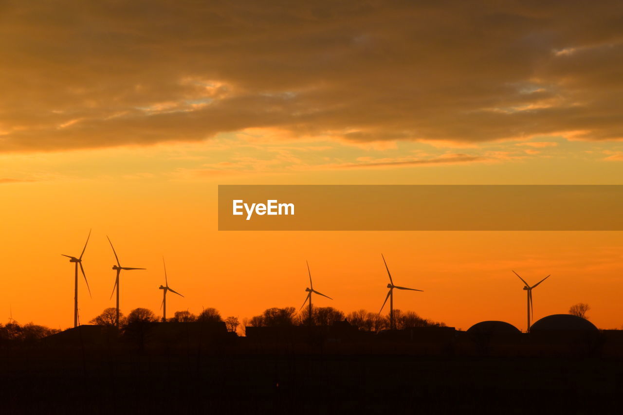 SILHOUETTE WINDMILL ON FIELD AGAINST SKY DURING SUNSET