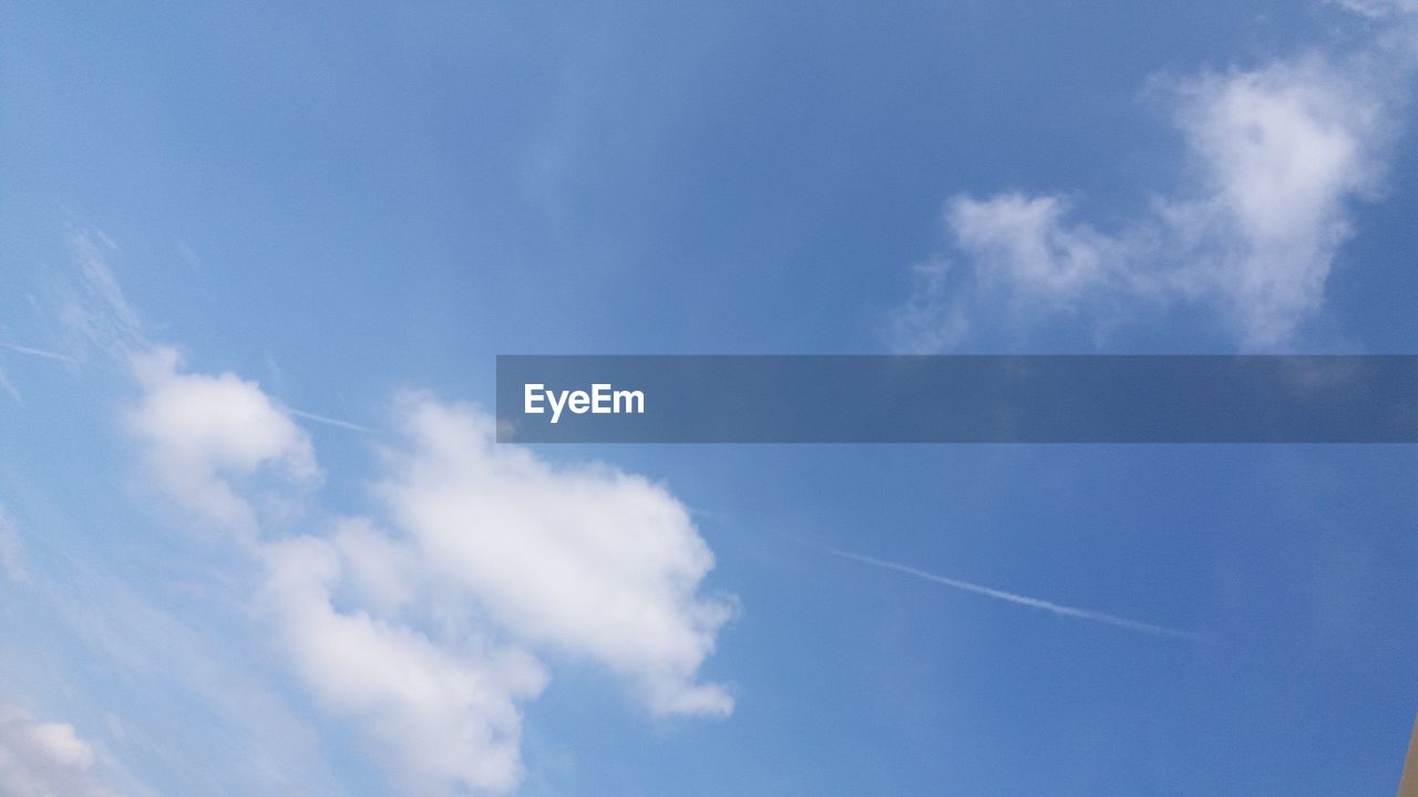 LOW ANGLE VIEW OF VAPOR TRAILS IN SKY