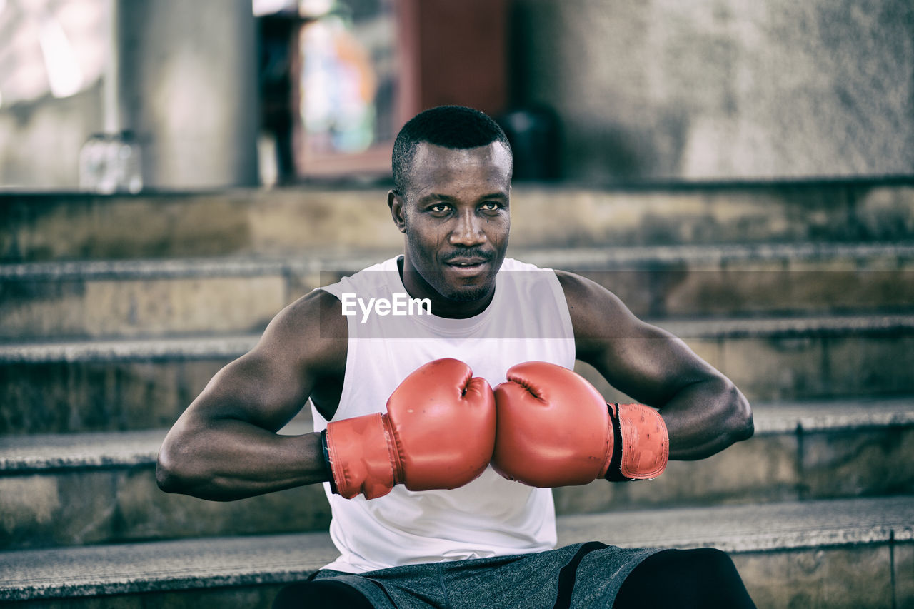 Portrait of man wearing boxing glove