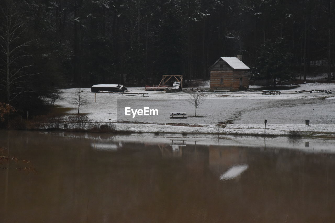 Reflection of building on lake during winter