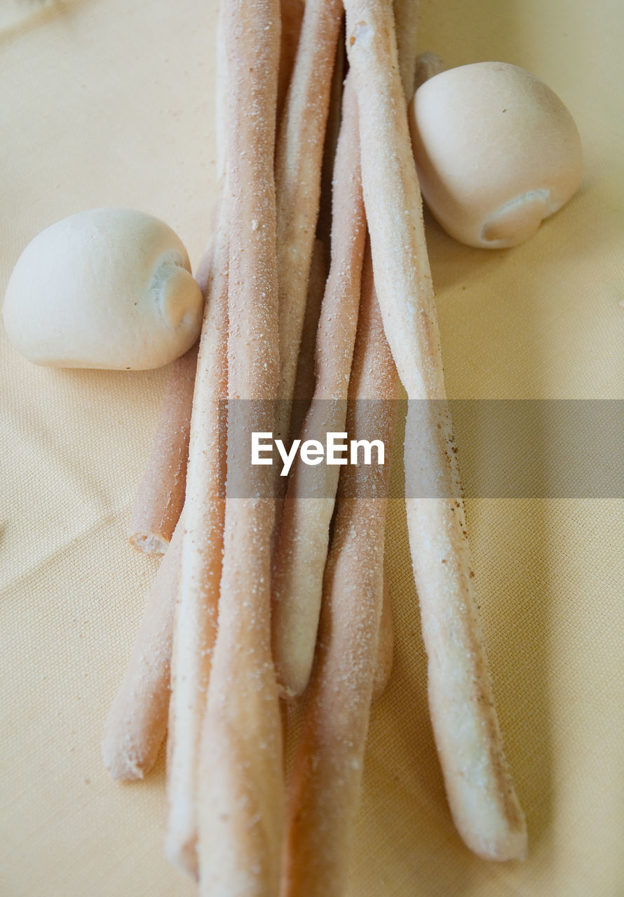 High angle view of breadsticks on table