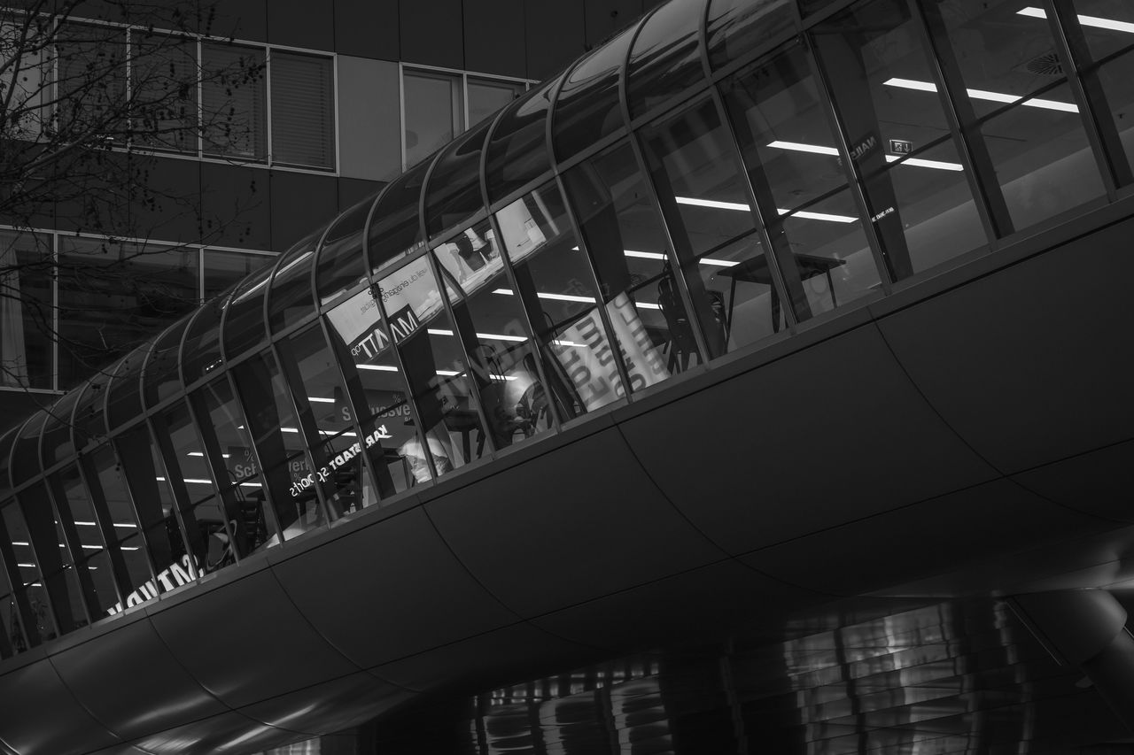 LOW ANGLE VIEW OF MODERN GLASS BUILDING