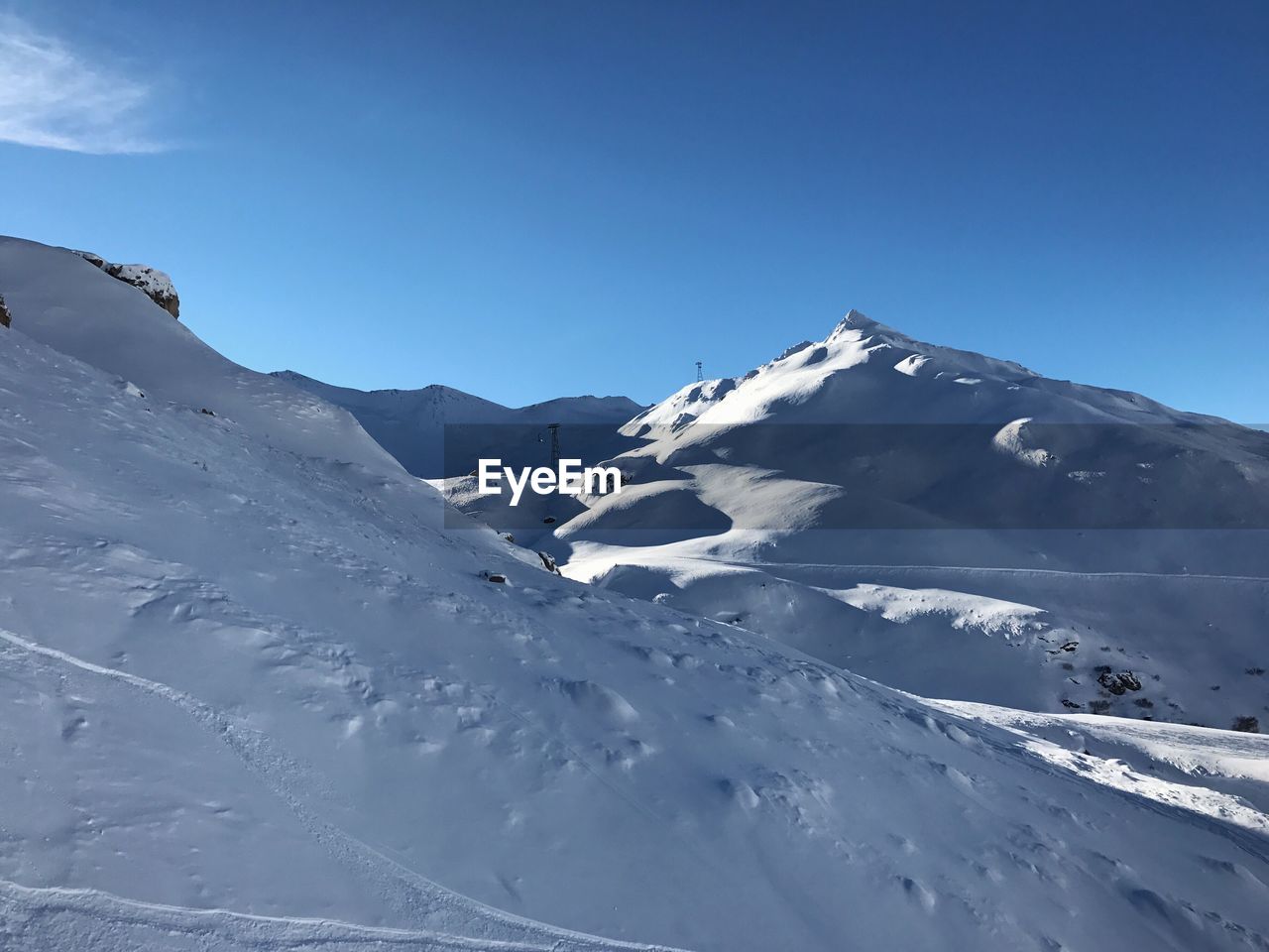 Low angle view of snowcapped mountains against sky