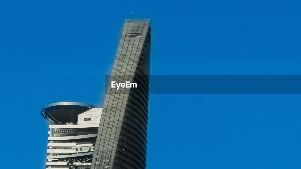 Low angle view of skyscrapers against clear blue sky