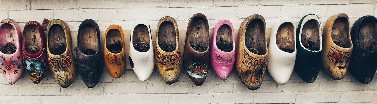 Row of old shoes hanging on wall