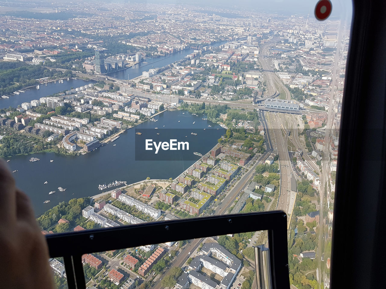 AERIAL VIEW OF CITY SEEN THROUGH AIRPLANE WINDOW IN BUILDING