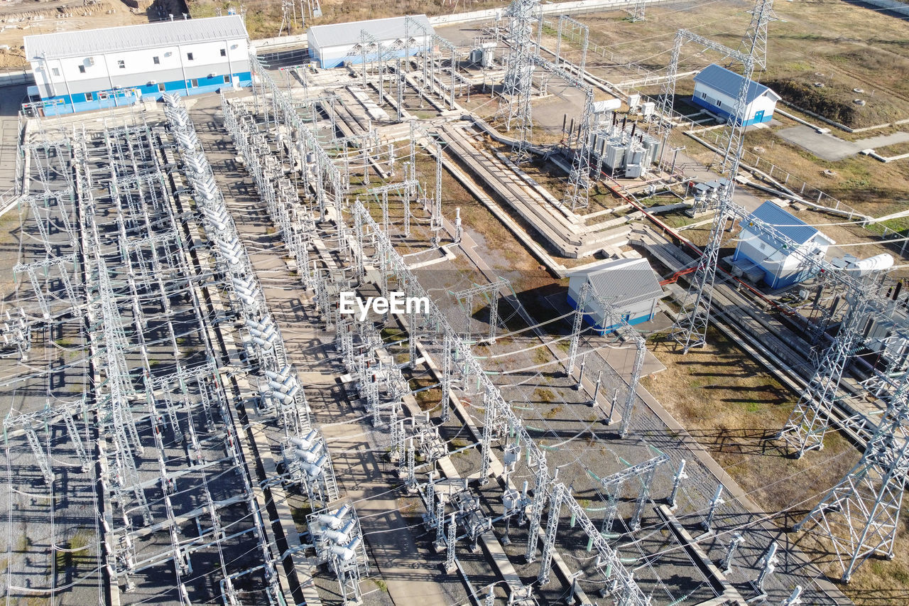 High-voltage electric transformation power plant. high-voltage power lines on pylons and transformer