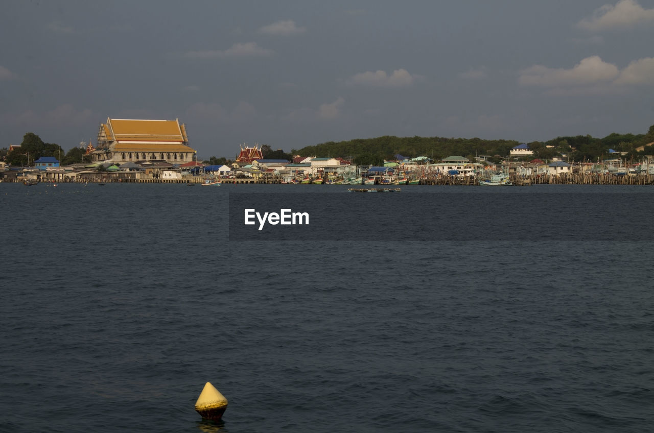 Scenic view of sea and buildings against sky