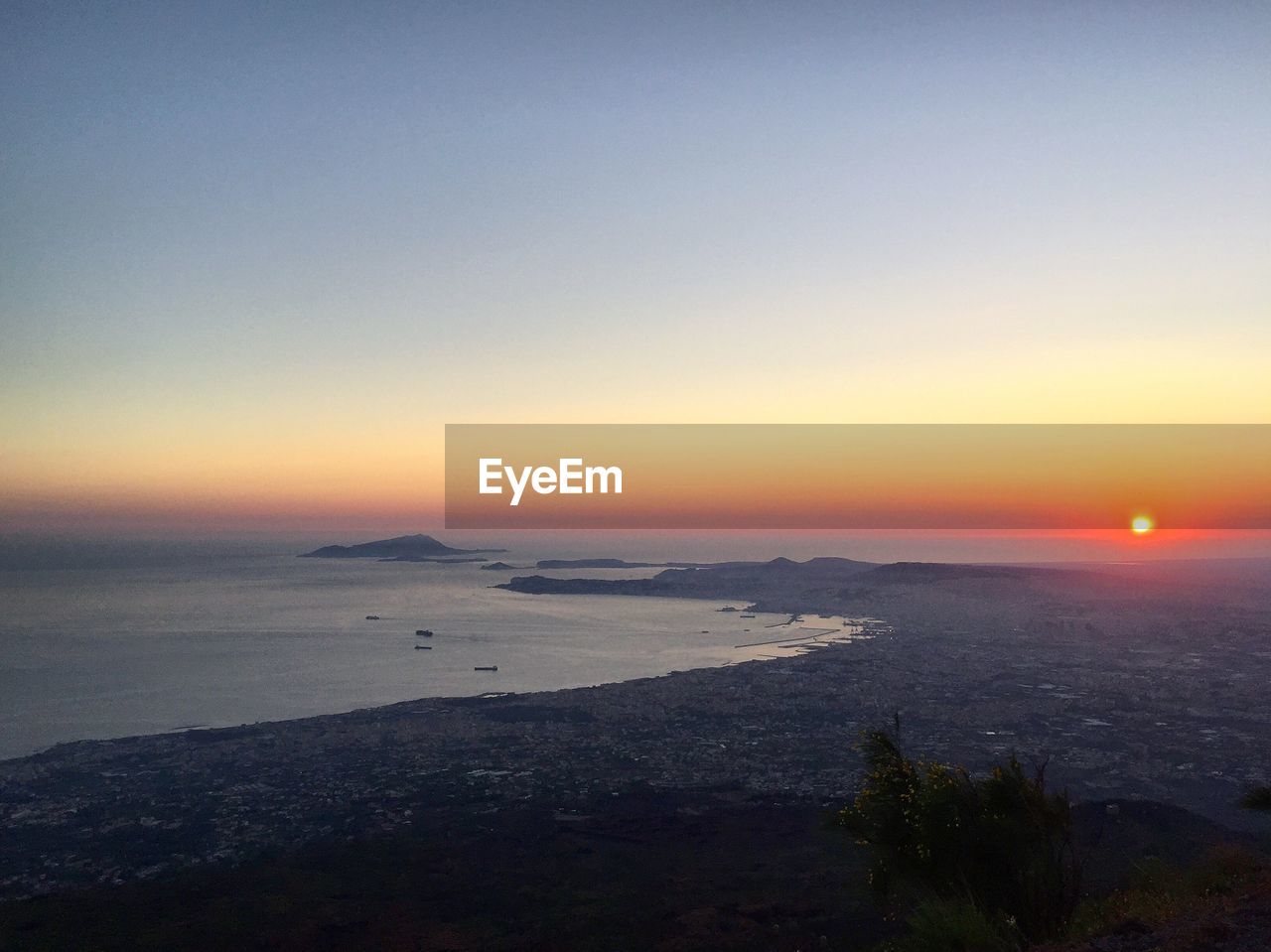 SCENIC VIEW OF BEACH AGAINST CLEAR SKY AT SUNSET