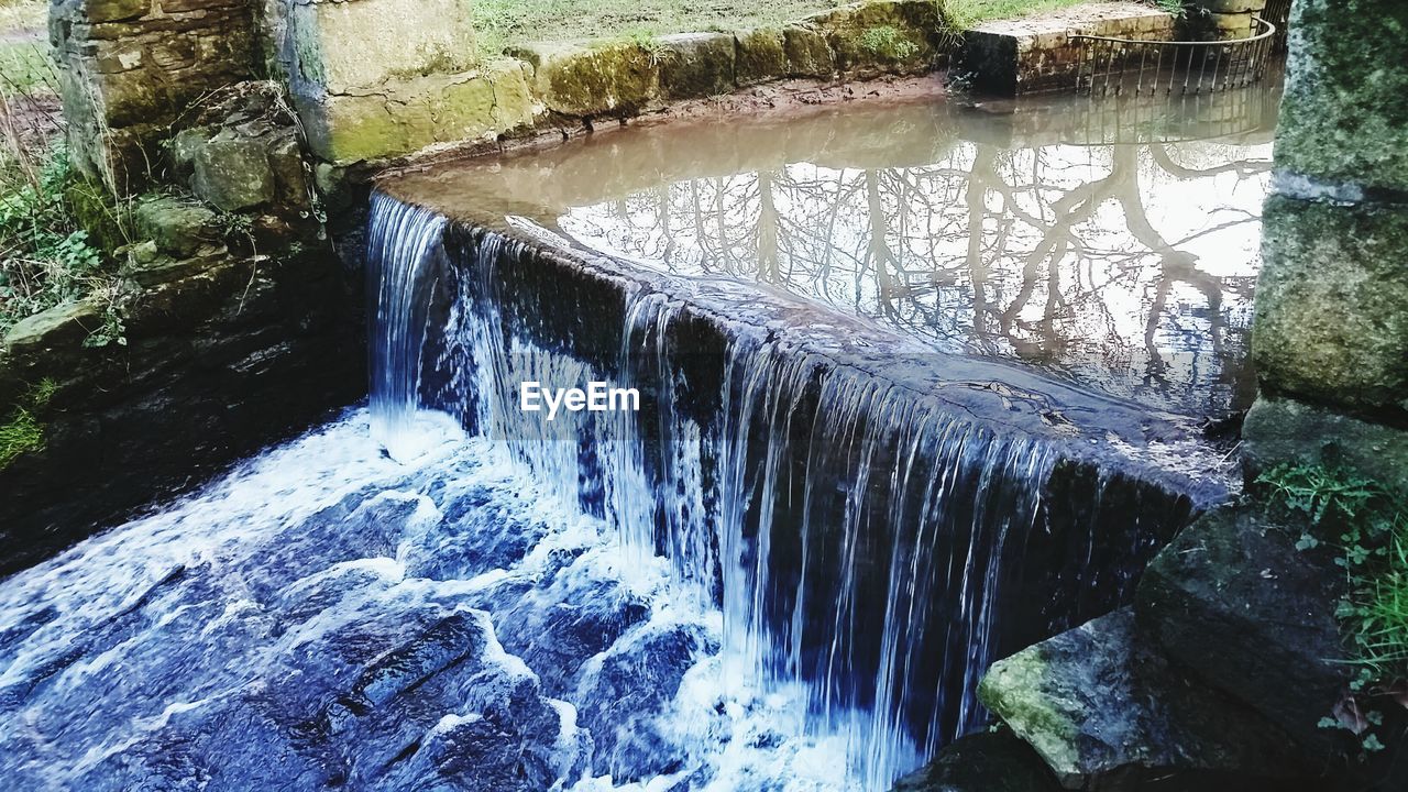 STREAM FLOWING THROUGH ROCKS