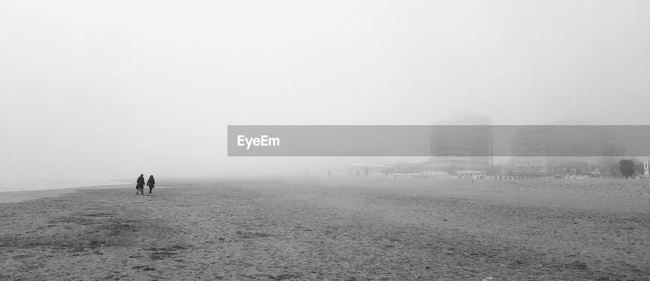 Scenic view of beach against sky during foggy weather