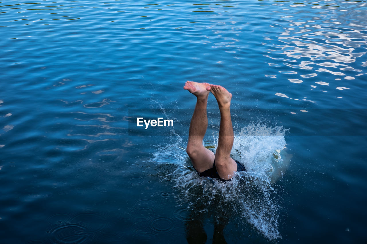 High angle view of man jumping in sea