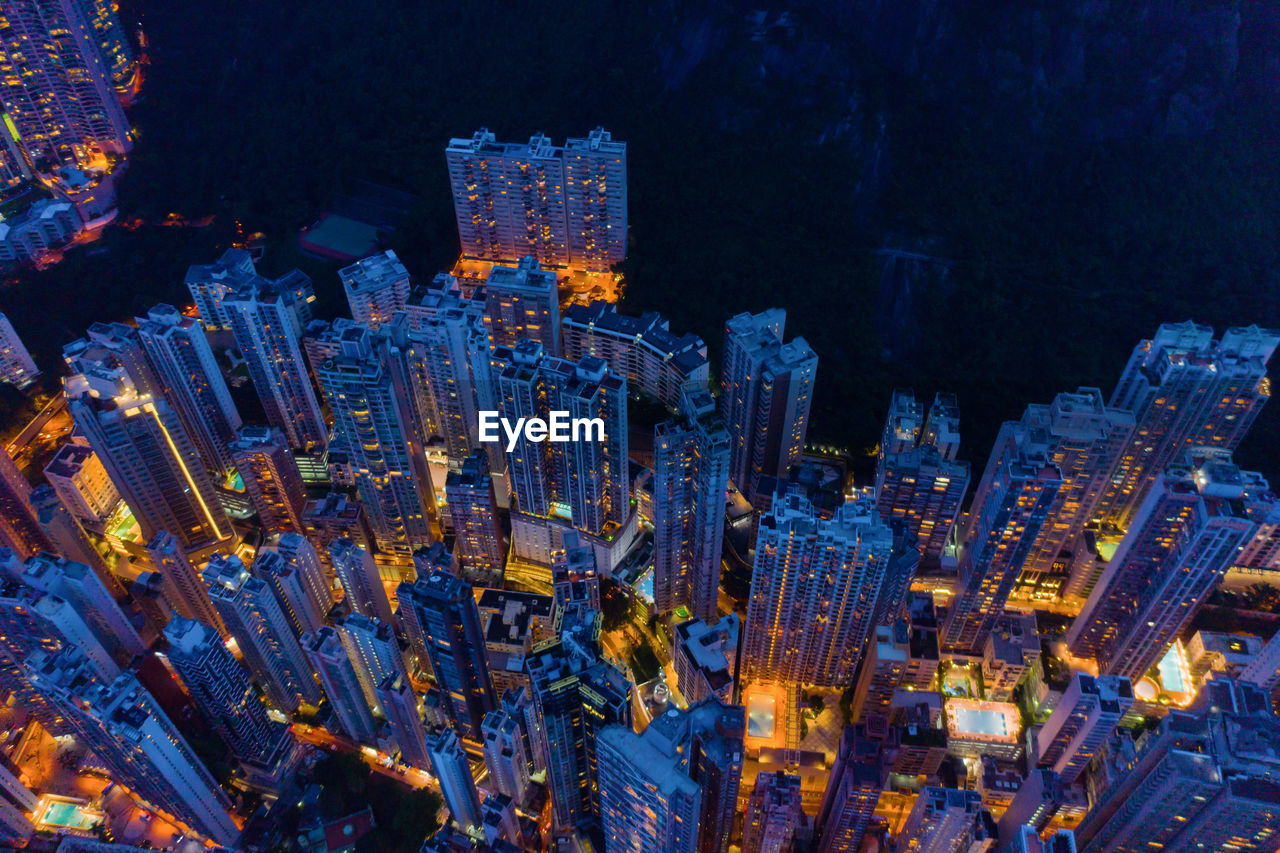 High angle view of illuminated buildings in city at night