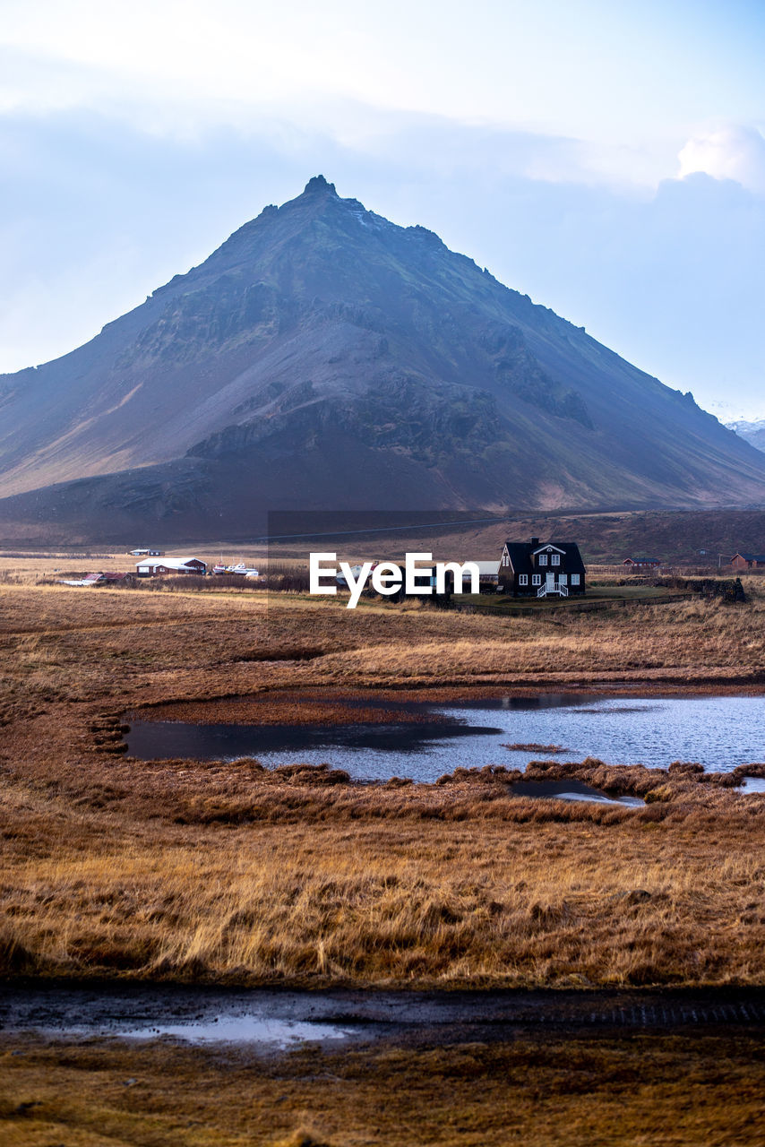 Scenic view of land and mountains against sky