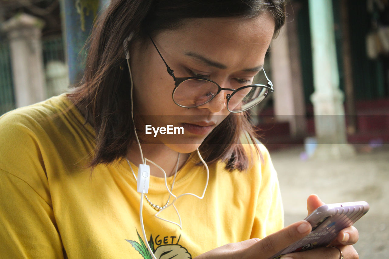 Young woman using smart phone outdoors