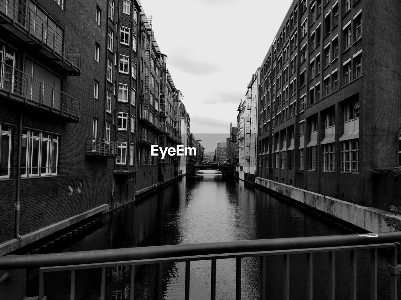 CANAL BY BUILDINGS AGAINST SKY