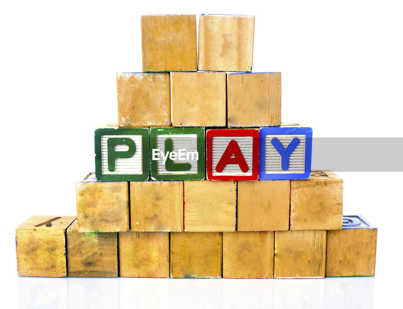 Wooden toy blocks with play text on white background