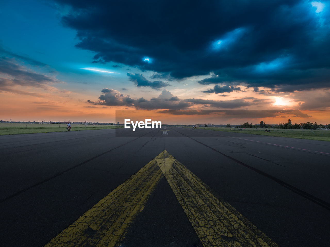 Airport runway at tempelhofer feld against cloudy sky at dusk