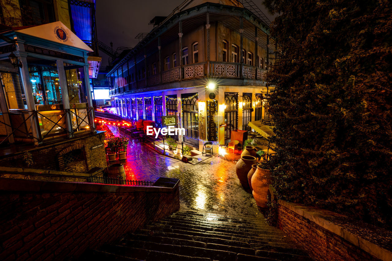 night, architecture, illuminated, evening, building exterior, built structure, city, light, street, darkness, building, urban area, lighting, nature, cityscape, travel destinations, outdoors, plant, lighting equipment, no people, tree, transportation, reflection, water, road, residential district