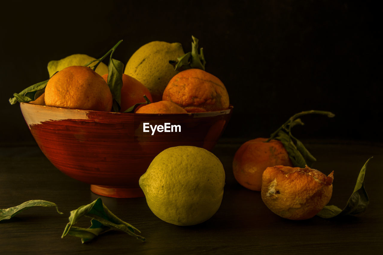 Close-up of citrus fruits in bowl on table