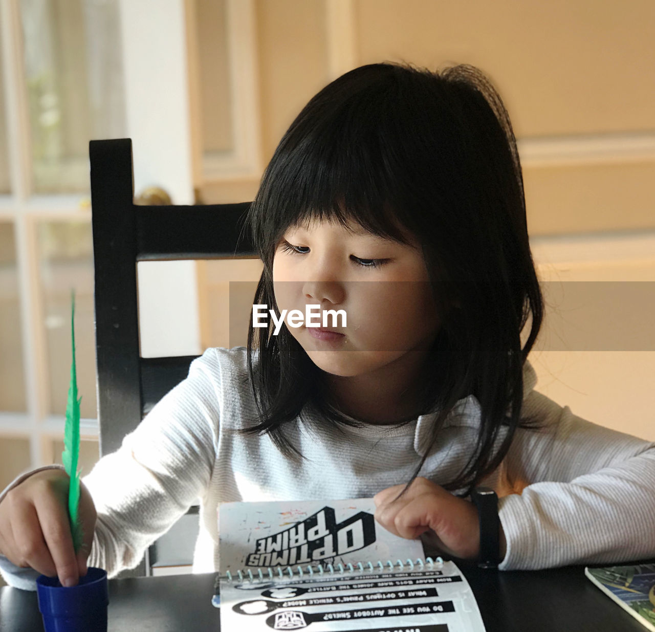 Portrait of a girl sitting at table