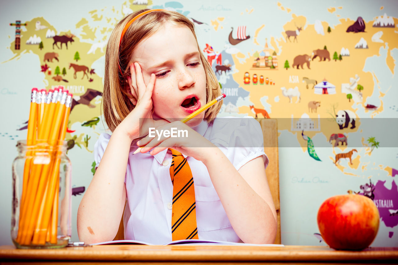 CLOSE-UP OF BOY PLAYING WITH COLORFUL AT HOME