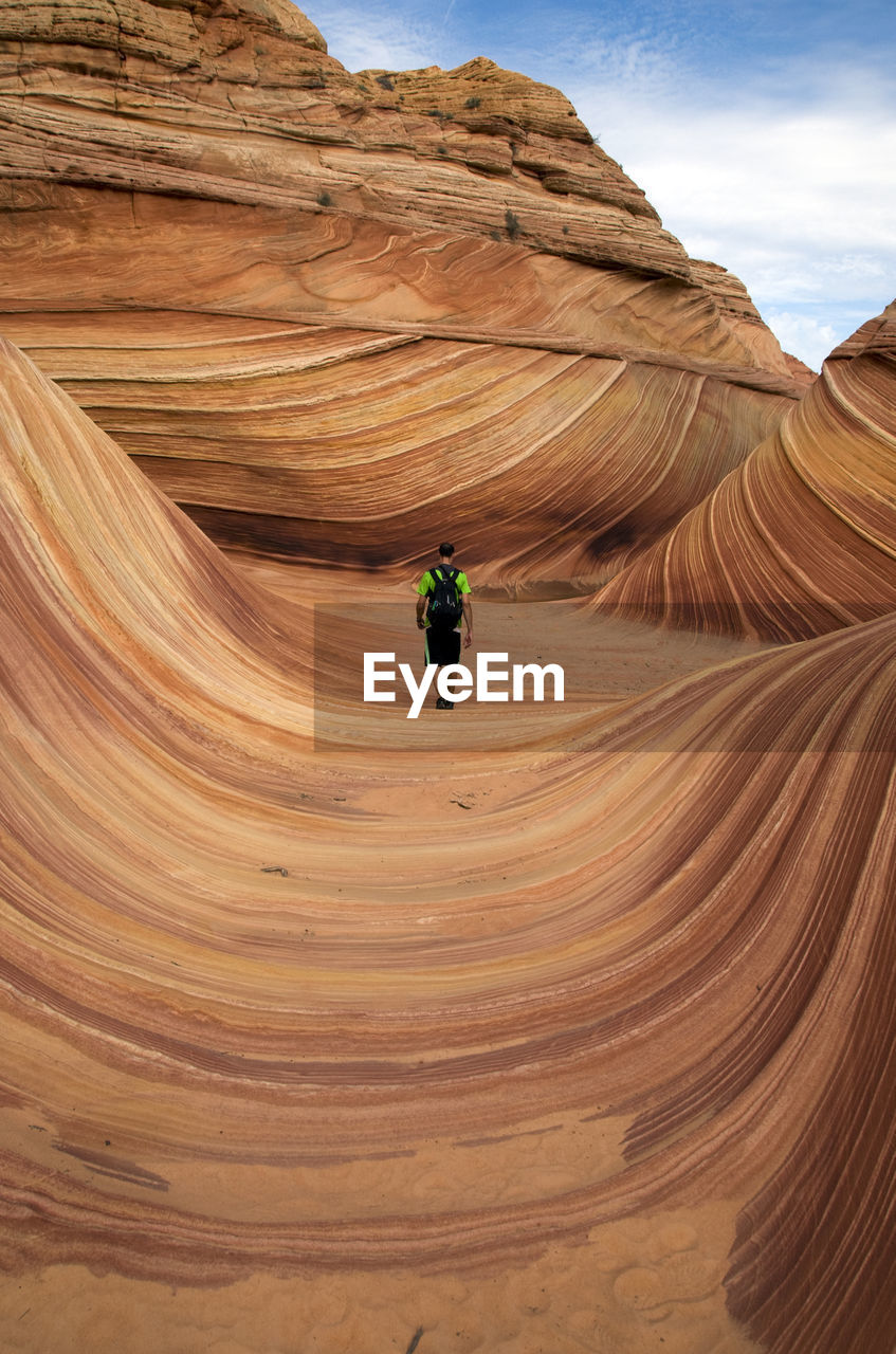 Man standing on rock formations in arizona