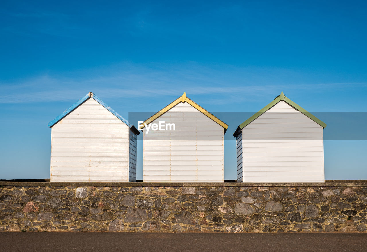 Low angle view of beach huts against sky