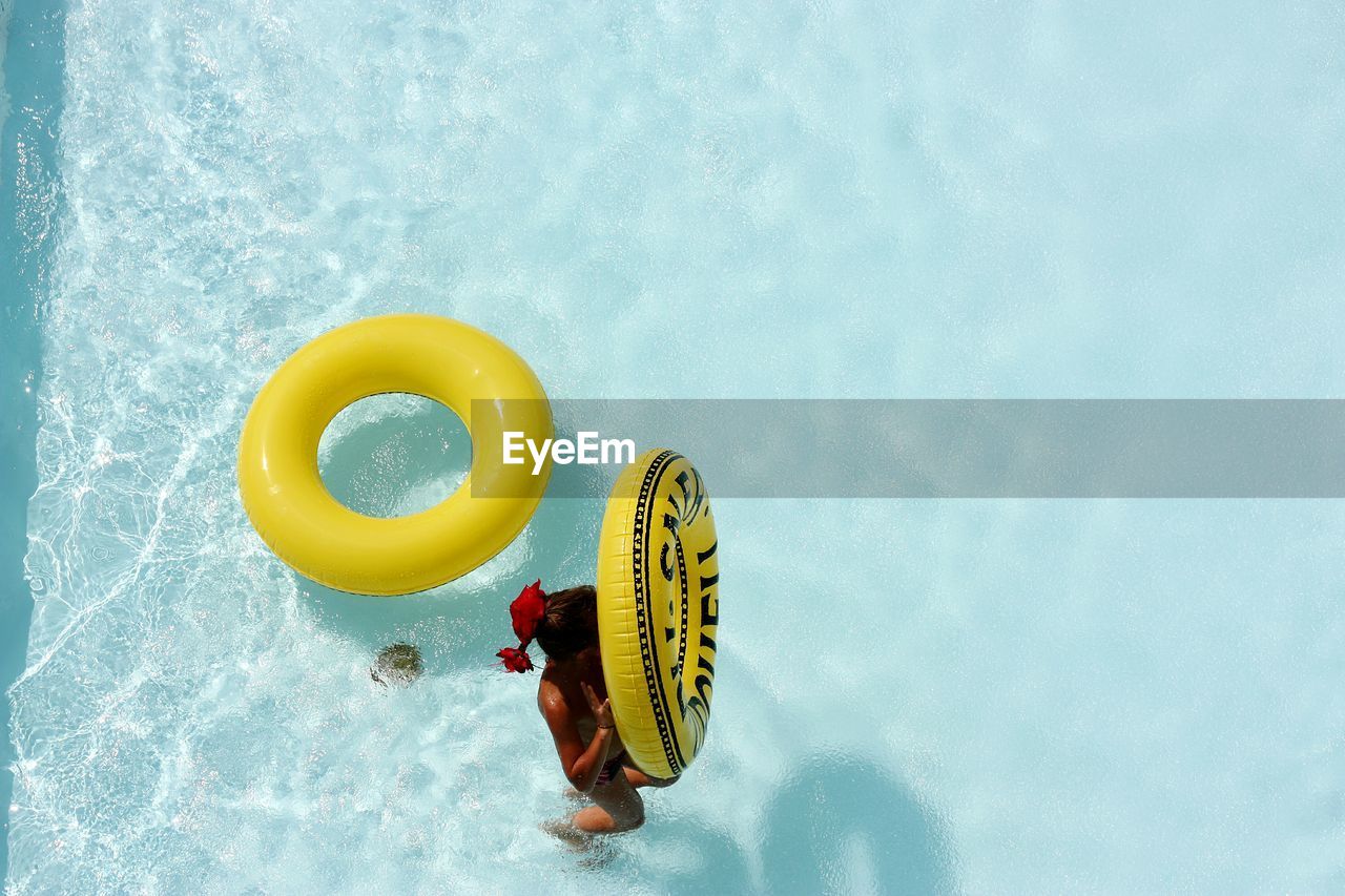 Woman holding life belt in pool