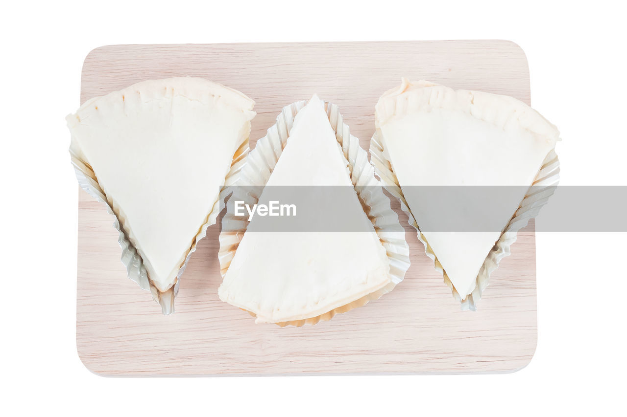HIGH ANGLE VIEW OF ICE CREAM ON TABLE AGAINST WHITE BACKGROUND
