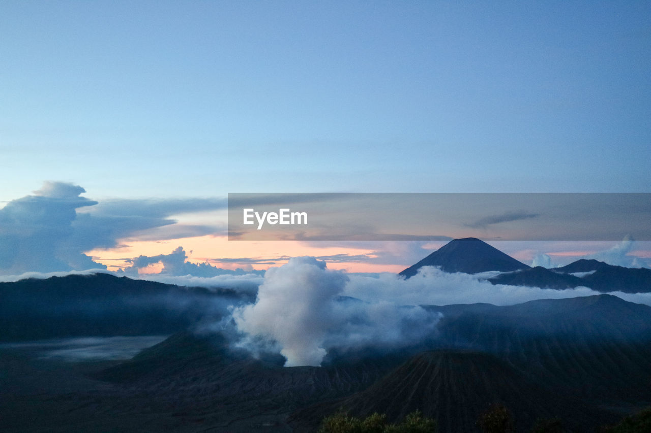 Aerial view of snowcapped bromo mountains against sky during sunrise