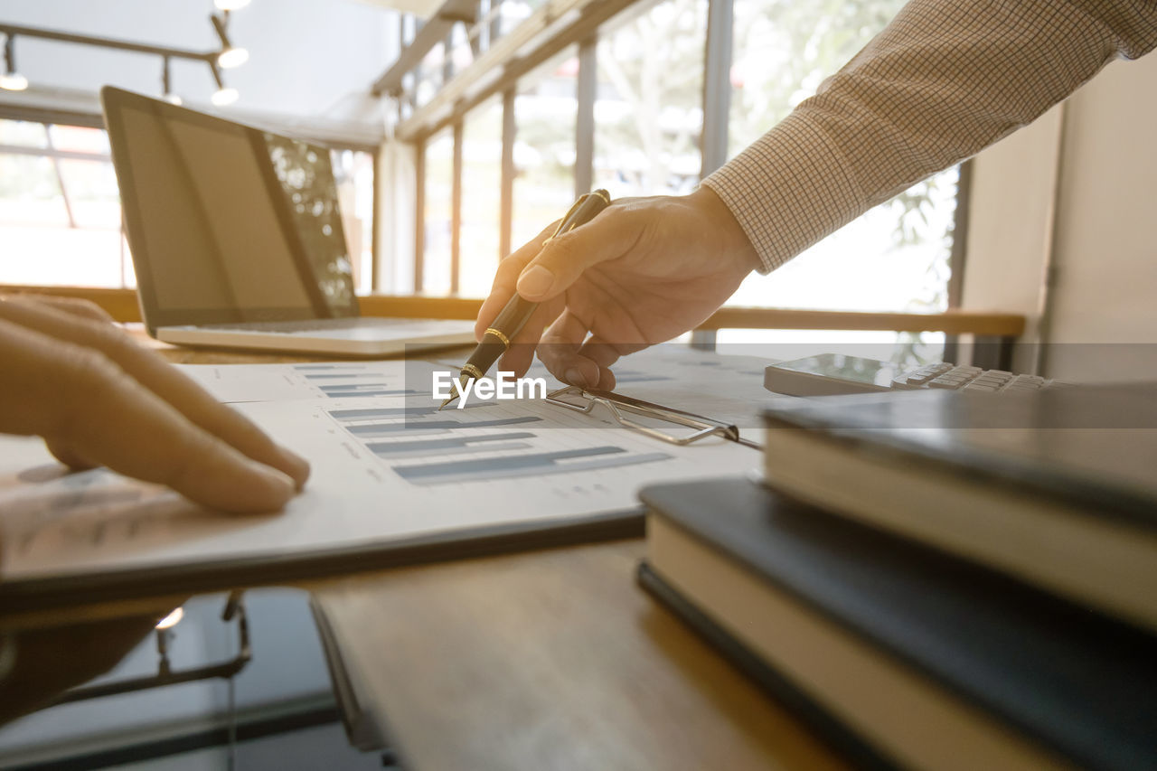 Close-up of business colleagues working in office