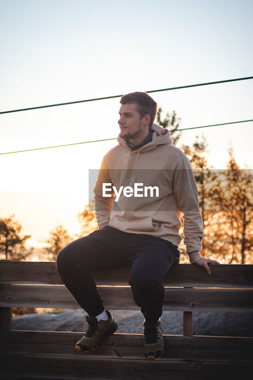 Man beige sweatshirt walks up the stairs to top of vuokatinvaara mountain, in kainuu region, finland