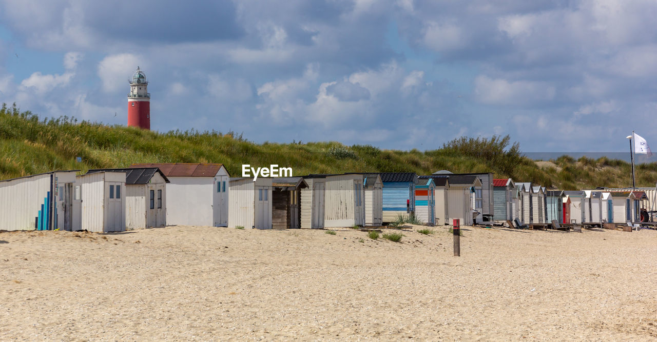 LIFEGUARD HUT ON BEACH AGAINST BUILDINGS