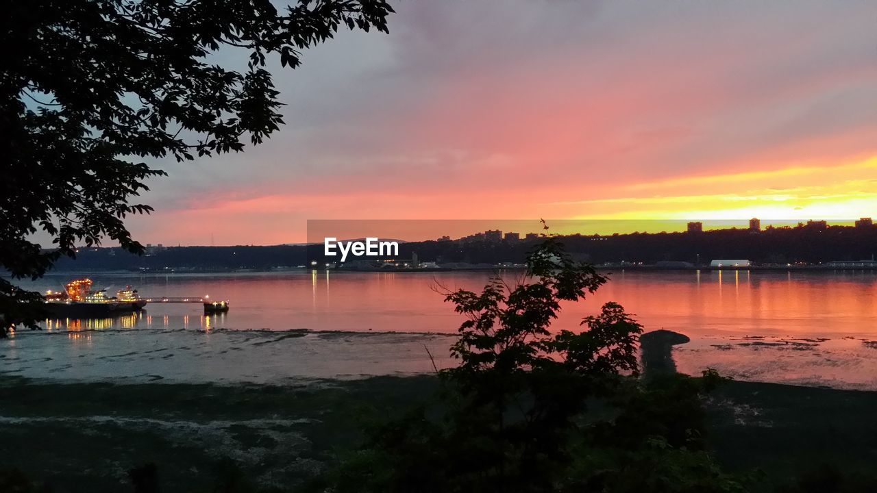 SCENIC VIEW OF LAKE AGAINST ORANGE SKY