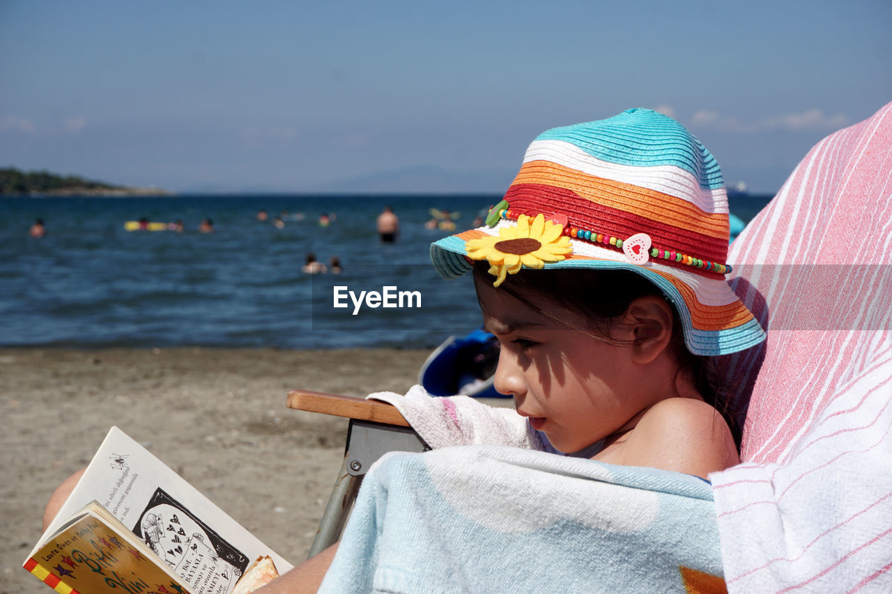 The child reading books on the beach